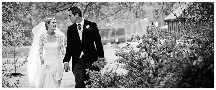 homerton college bride groom tom ellen walking hand in hand