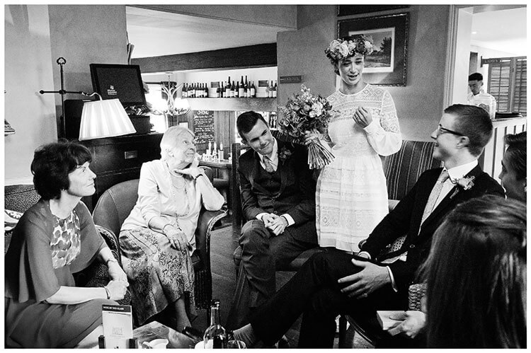 bride groom talking to wedding guests in the lounge of the old bridge hotel