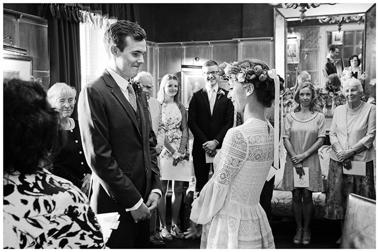bride groom looking at each other during ceremony at old bridge hotel