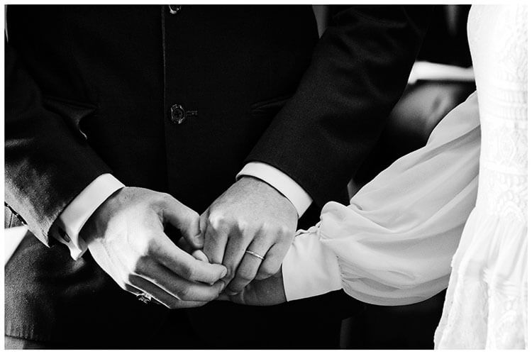 bride groom holding hands during ceremony