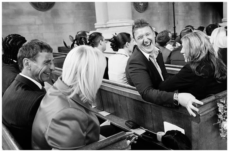 wedding guests laughing in church