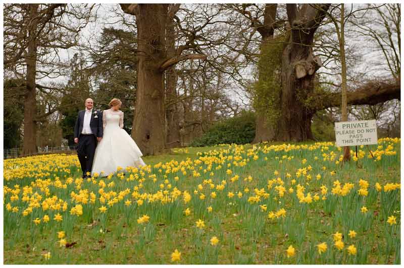 do not enter sign bride groom walking through daffodils in Woburn Sculpture Gallery gardens