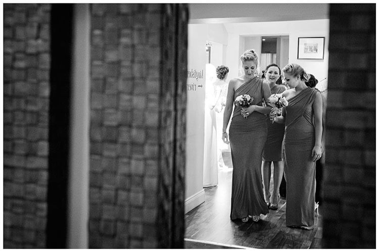 bridesmaids practice their entrance reflected in mirror
