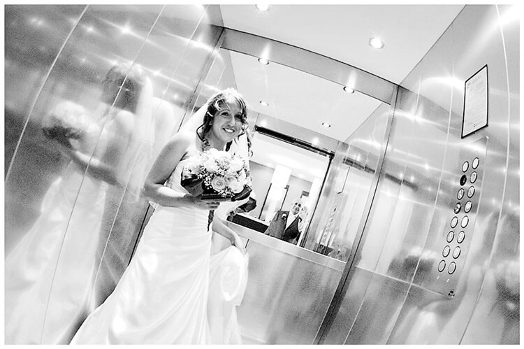 lake garda wedding photography bride in lift looking at father in door way
