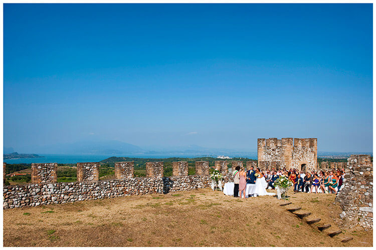 wedding Ceremony Castello di Lonato under a deep blue sky ake garda in background