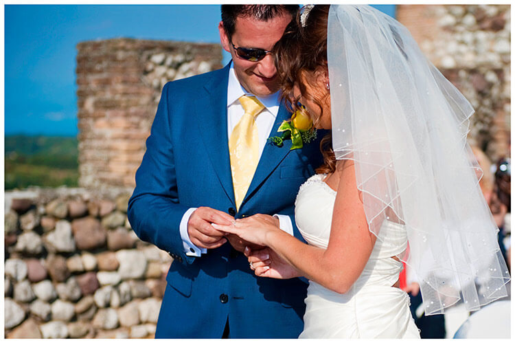 lake garda wedding photography groom places ring on brides finger