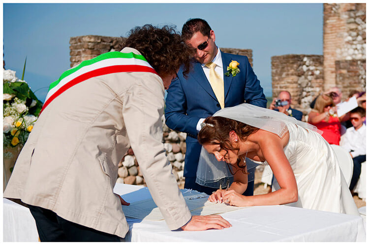 lake garda wedding photography bride signs register groom watches