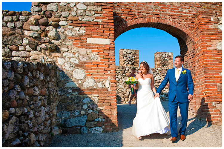 lake garda wedding photography bride groom walking through castle gate