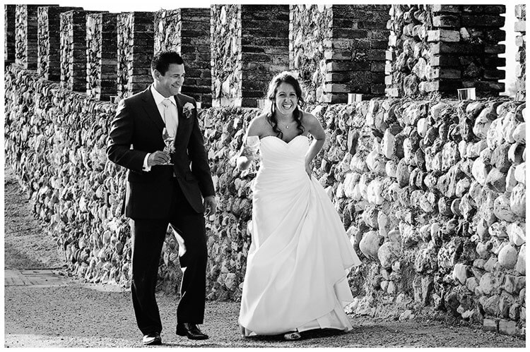 lake garda wedding photography smiling bride groom walking on ramparts of castle