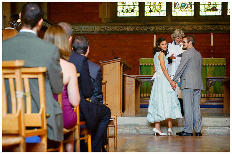 Michaelhouse wedding bride looks back at guests during ceremony