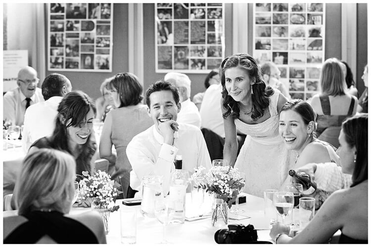 Michaelhouse wedding laughing guests sat at table