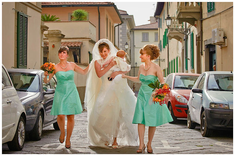 Castel di Poggio wedding bride and bridesmaids walking down Italian street