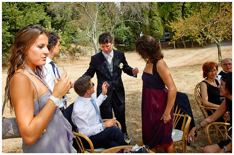 Castel di Poggio wedding groom talking to sitting guests