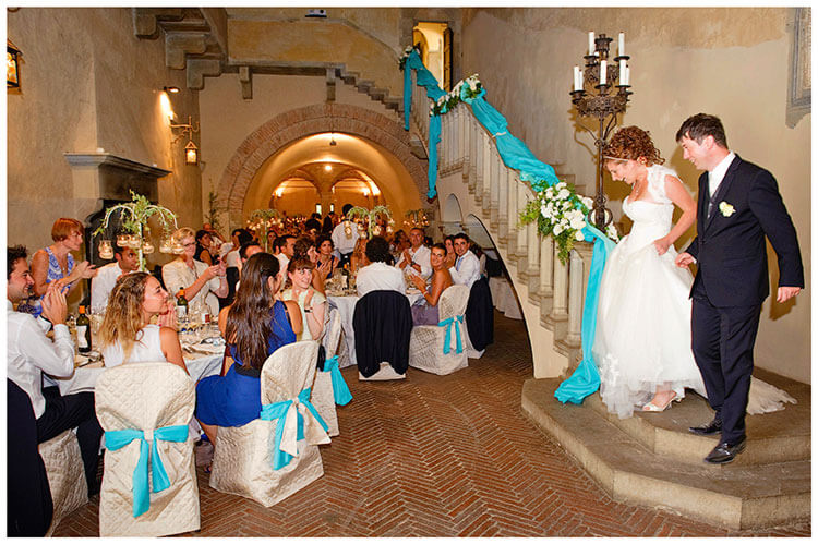 Castel di Poggio wedding brid egroom walking down stairs to wedding dinner