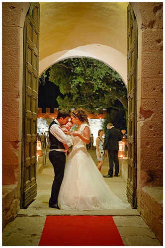 Castel di Poggio wedding bride groom in doorway kissing baby flower girl