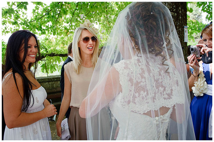 Fraternita di Romena wedding bride talking to female guests taking photo