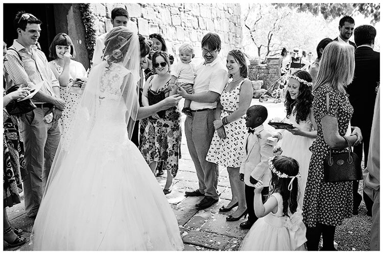 Fraternita di Romena wedding bride talking to guest outside Church