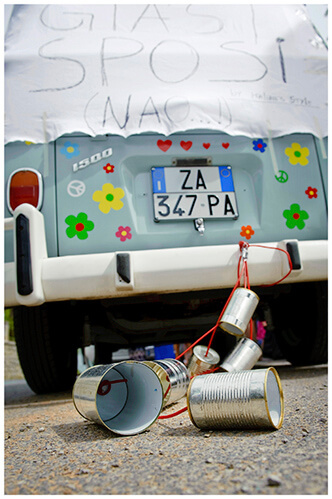 Fraternita di Romena wedding Italy cans and sign tied to back of flowery blue VW Camper