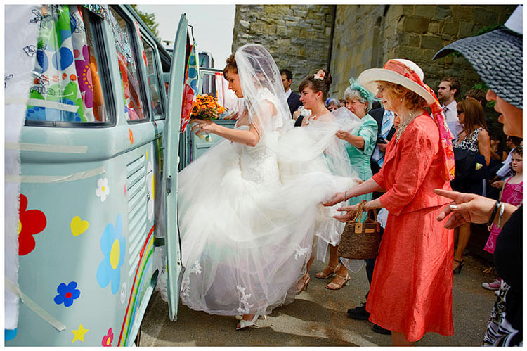Fraternita di Romena wedding bride getting into VW camper assisted by female guests