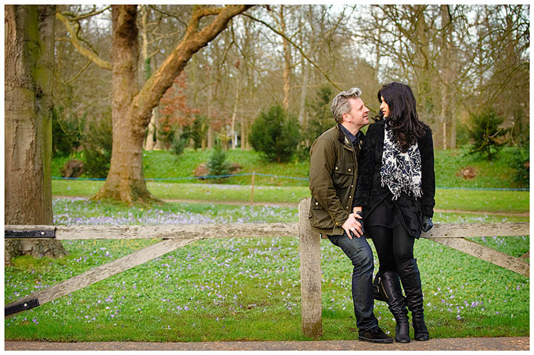 pre-wedding photography Cambridge couple sitting on low wooden fence
