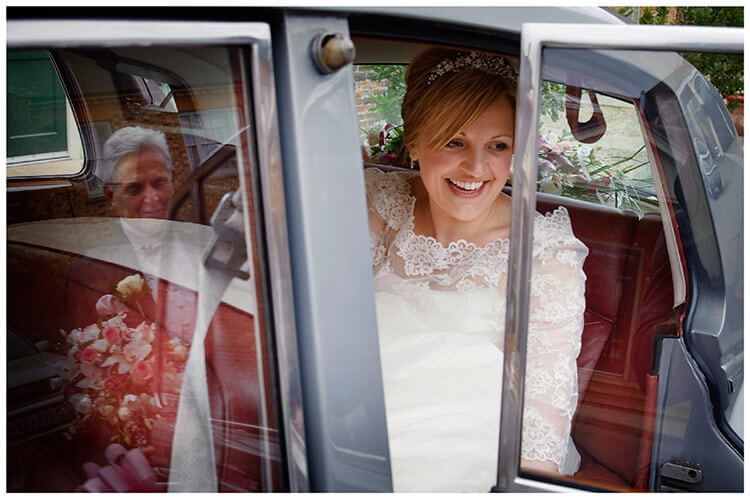 Woburn Church wedding smiling bride in car father reflection in window