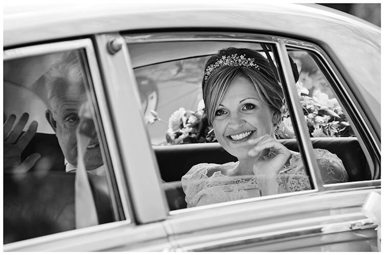 Woburn Church wedding smiling bride arrives in car waving