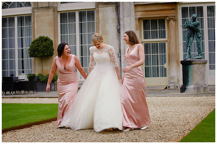 Woburn Sculpture Gallery wedding bride and bridesmaids laughing