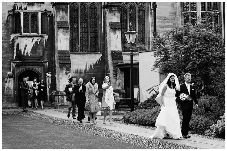 Christ’s College wedding walking happy couple followed by guests
