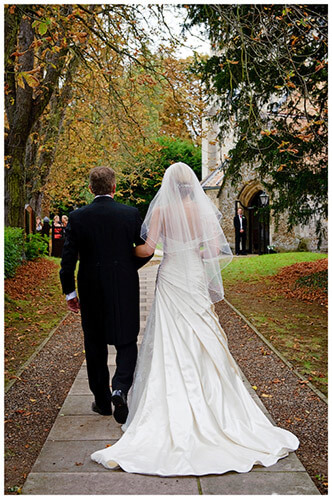 Wedding Photography at Tattersalls bride and father walking towards church