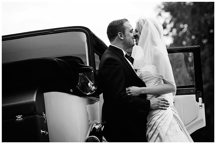 Wedding Photography at Tattersalls bride groom kiss car