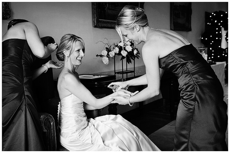 Wedding Photography at Tattersalls bridesmaids helping bride