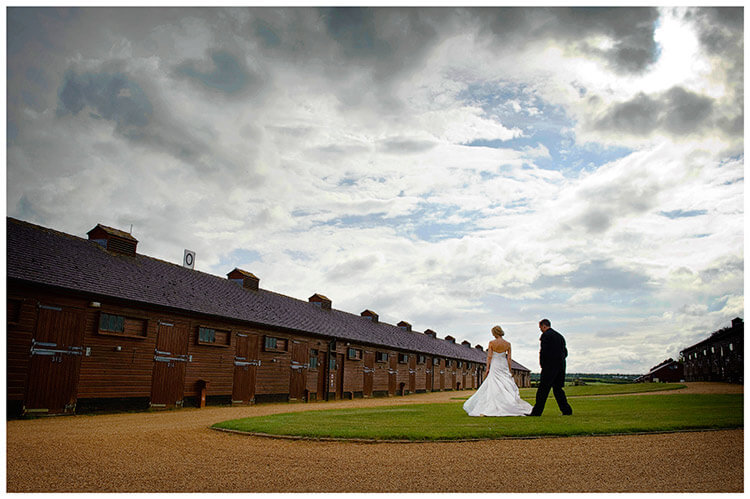 Wedding Photography at Tattersalls bride groom walking towards stables