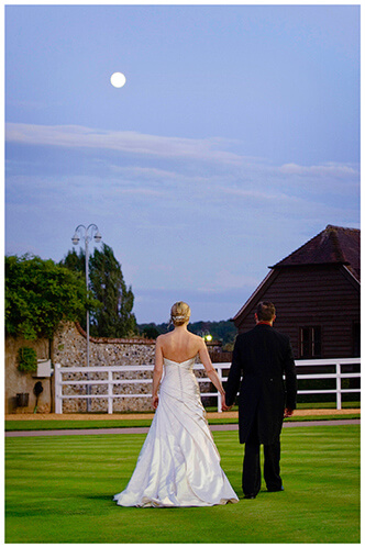 Wedding Photography at Tattersalls bride groom walking holding hands under moon