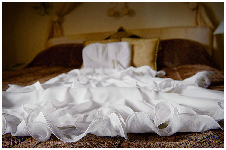 Sheene Mill wedding Bridal dress laid out on bed