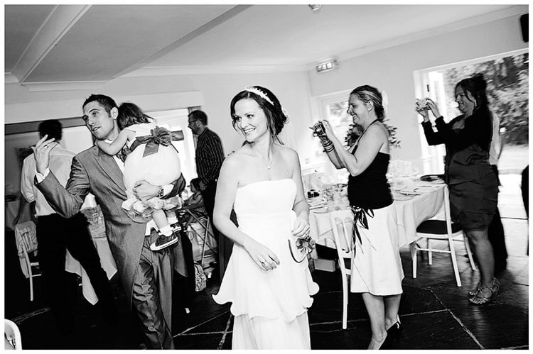 Sheene Mill wedding bride groom enter dining room carrying child guests take photos