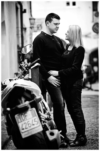 Pre-Wedding Photography in Florence couple embrace near motorbike