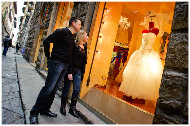 Pre-Wedding Photography in Florence couple stop to admire wedding dress
