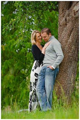 Pre-Wedding Photography shoot in Cambridgeshire couple embrace leaning against tree