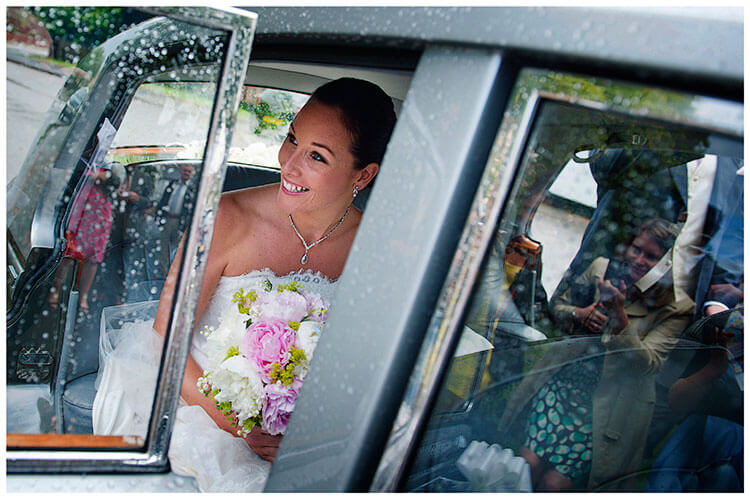 Buckden wedding bride in car guest reflected in window