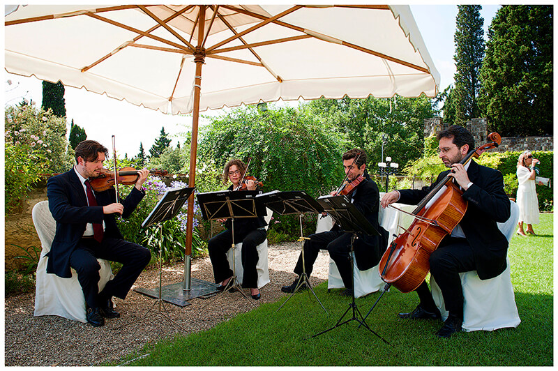wedding band quartet under large parrasol in gardens
