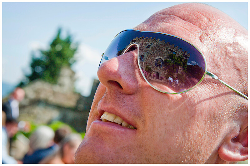 Castello di Vincigliata reflected in male guest sun glasses