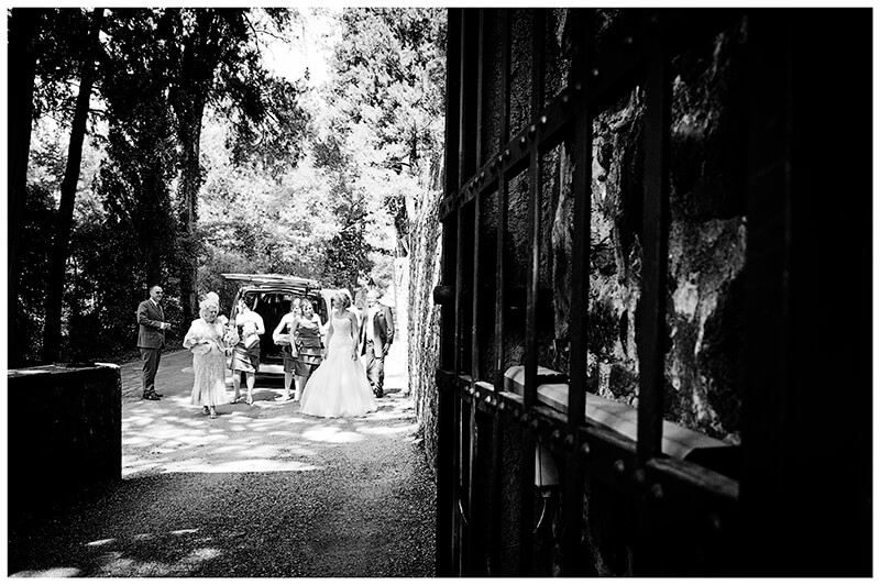 bridal party arrives at enterance to Castello di Vincigliata