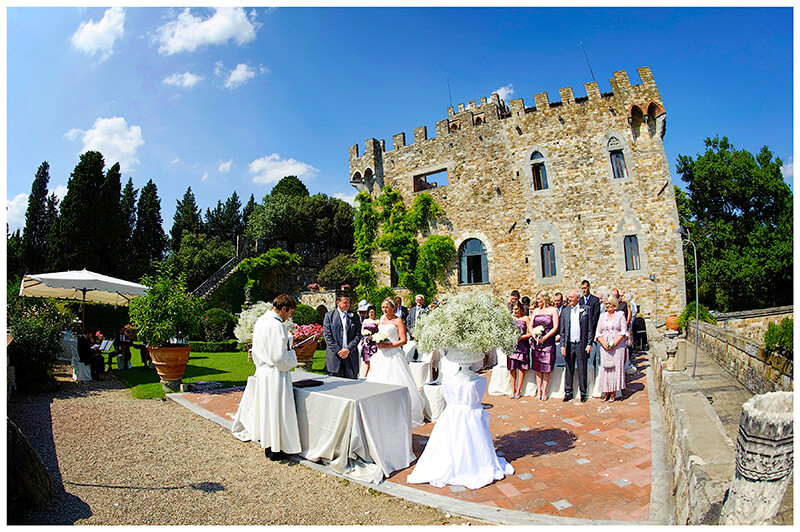 Castello di Vincigliata during wedding ceremony under blue sky