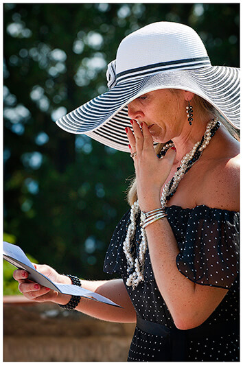 emotional reading from lady in white and black striped hat