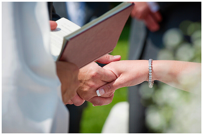 bride groom hold hands during ceremony