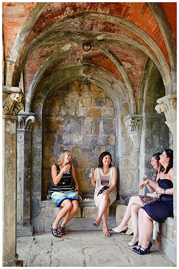 female guests talking under Italian portico