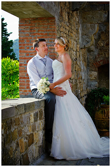 bridal couple embrace in castle tower