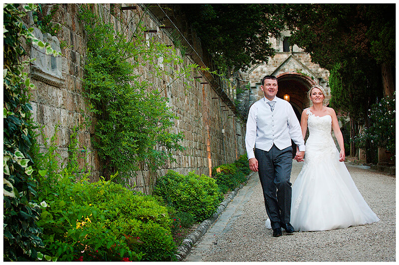unposed photo of bridal Couple walking around Castello di Vincigliata