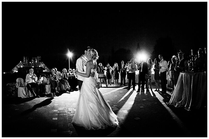 Bridal couples first dance surrounded by guests