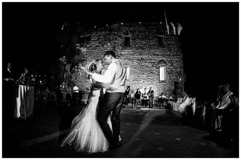 bride groom enjoying first dance in front of Castello di Vincigliata